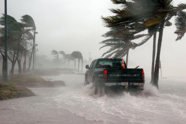 Truck driving through hurricane force wind and flooding